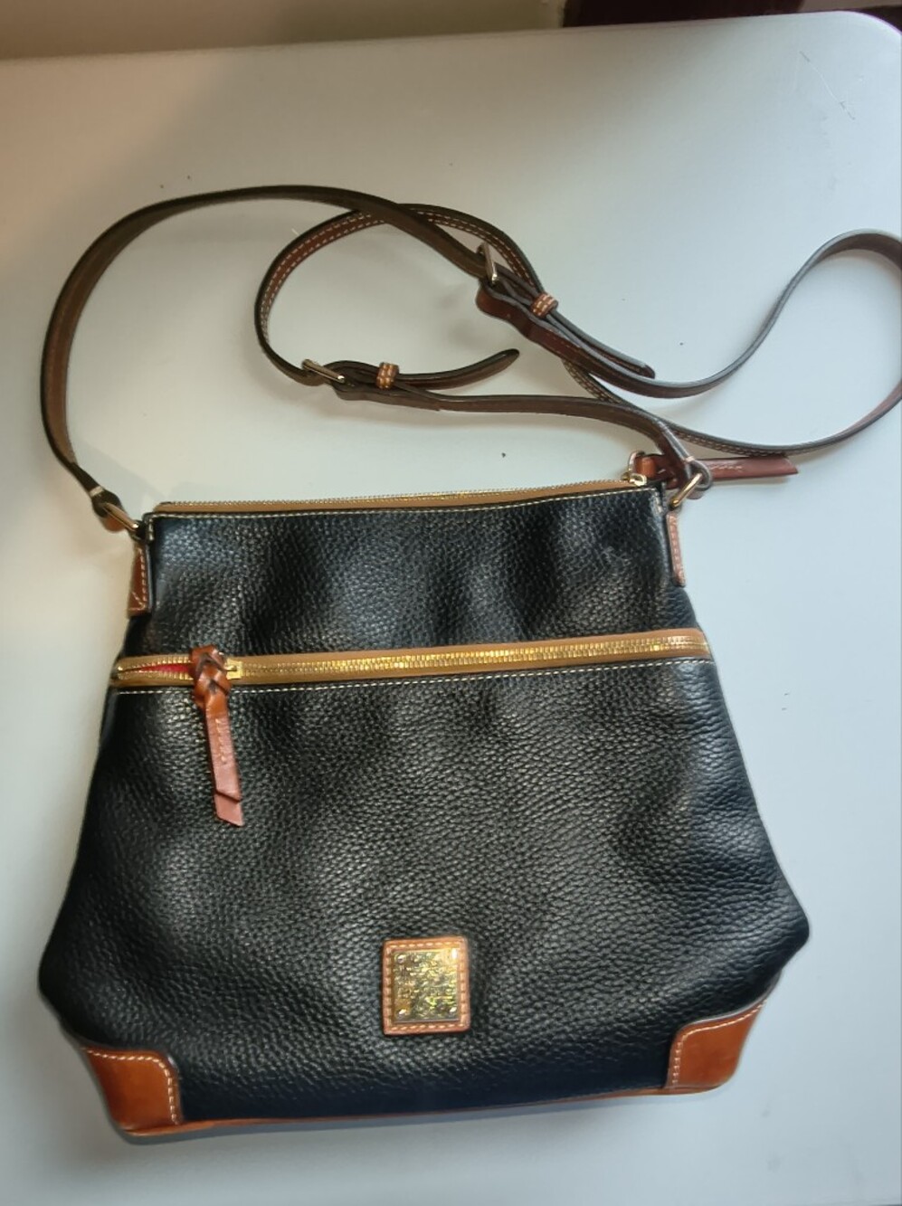 Dooney And Bourke Black and Brown Leather Crossbody Bag with Gold Accents